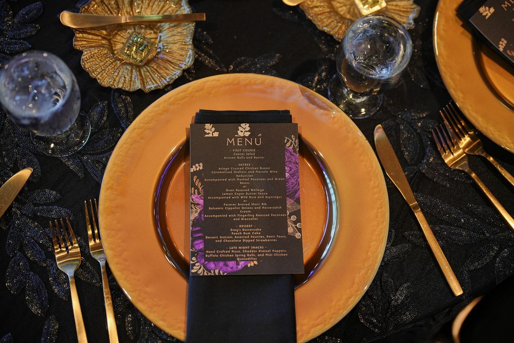 Gold charger and menu on a dark tablescape