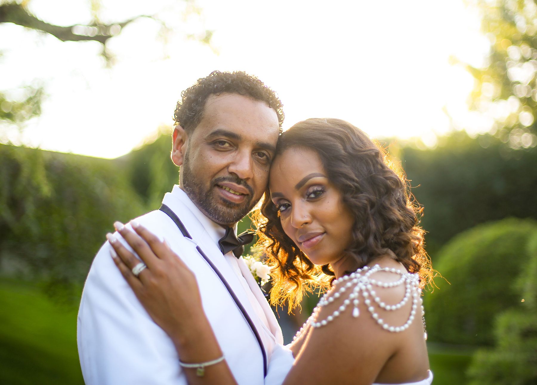 Couple cheek to cheek in golden-hour light