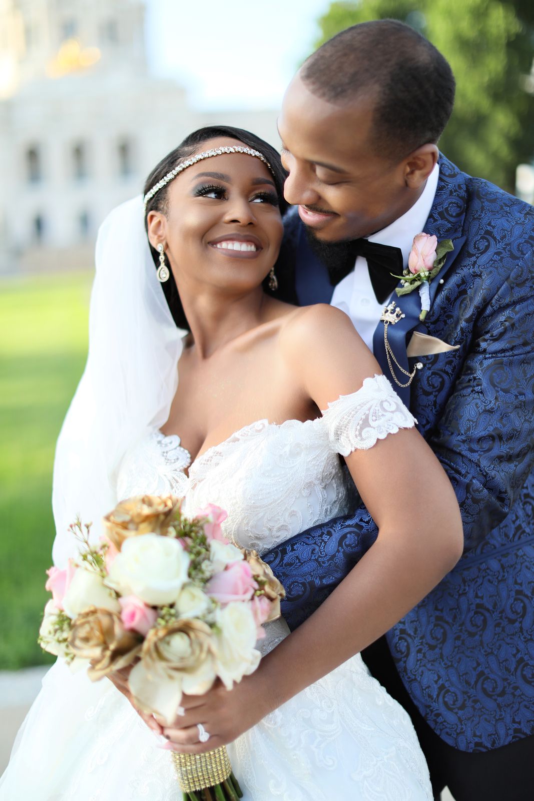 Groom embracing the laughing bride in front of the Capitol