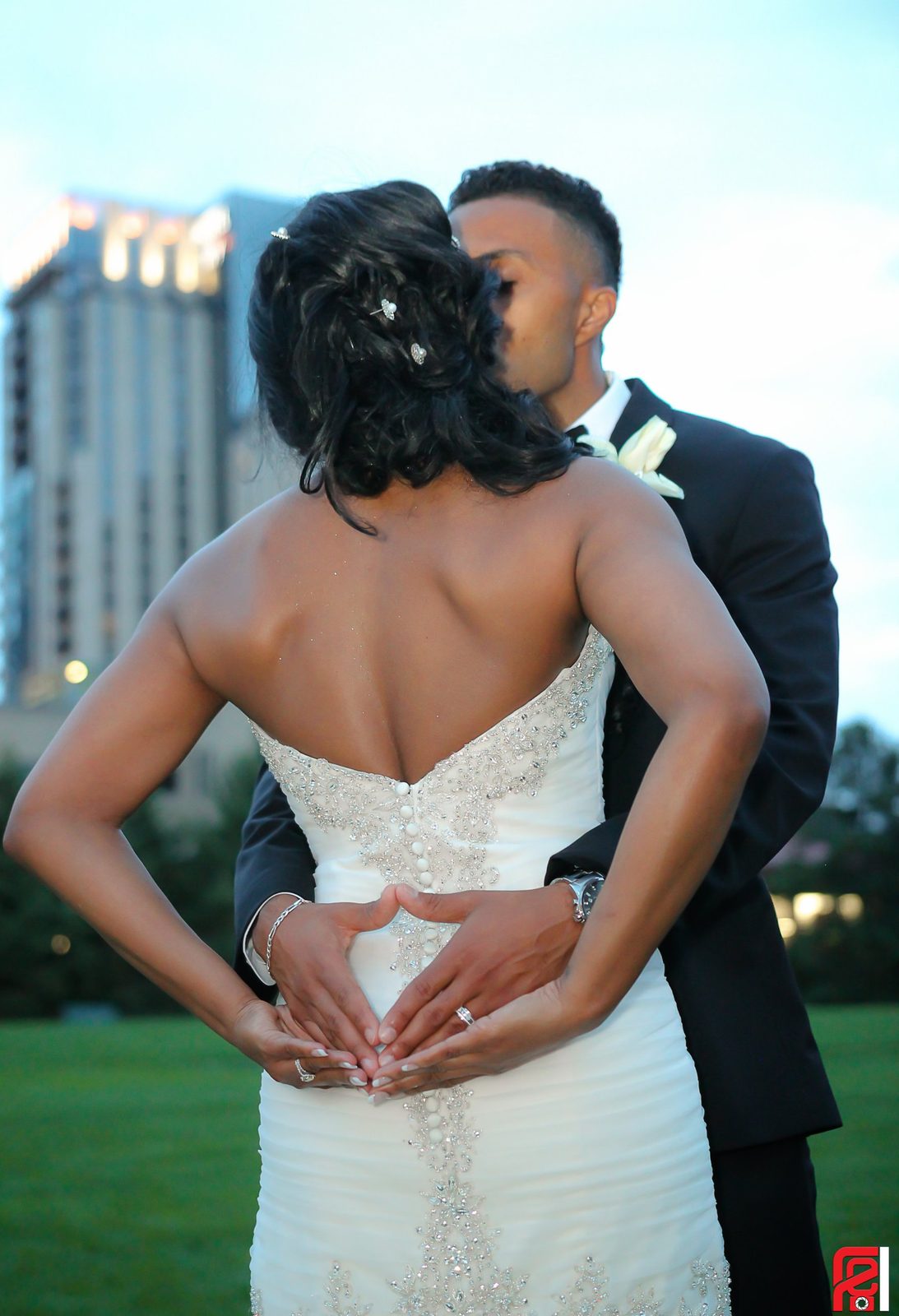 Couple at dusk, her hands forming a heart